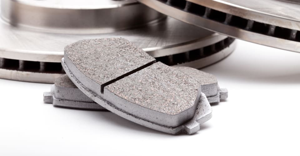 brake pads with brake disks in the background