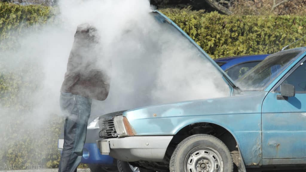 smoke blankets man as he opens car hood